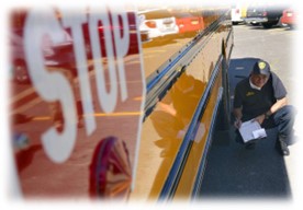 A school bus being inspected.