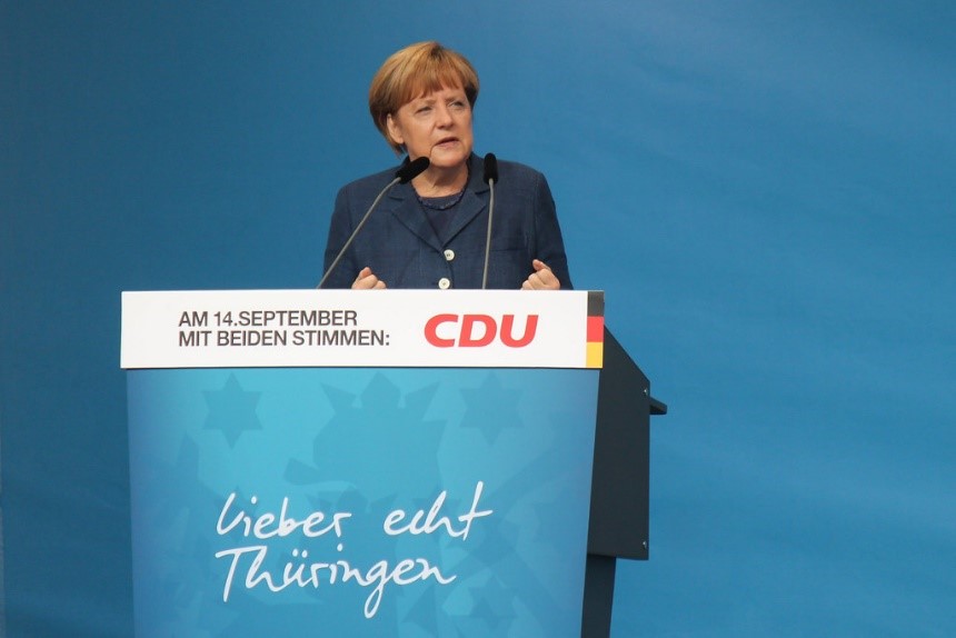 Woman giving a speech"Rede von Angela Merkel" by indeedous is licensed under CC BY 2.0.