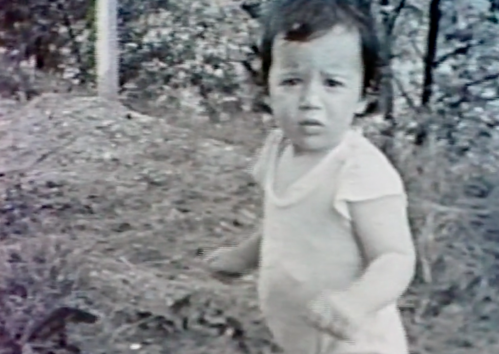 A black-and-white photo of the author as a child as she looks at the camera, a concerned look on her face.