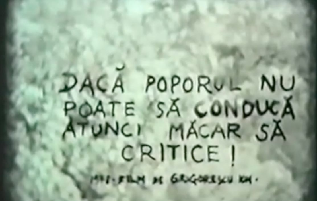 A faded film still of two men with handwritten Romanian text on top.