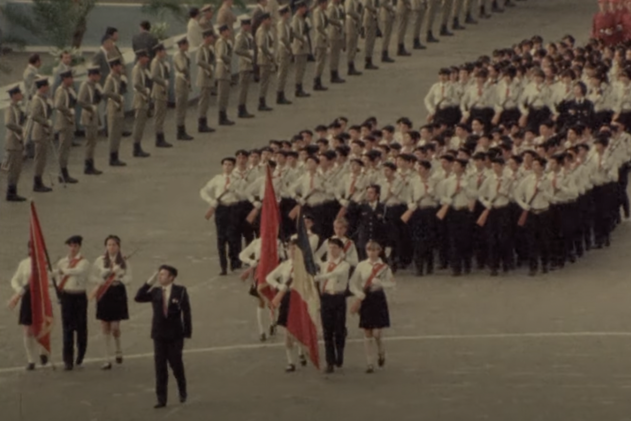 Picture of performers marching at an event in honor of dictator Nicolae Ceaușescu.