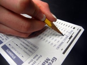 A person filling out a standardized test answer sheet