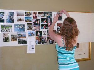 A girl putting up pictures